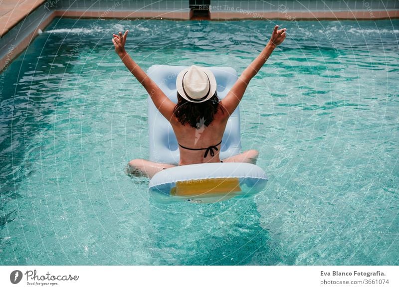 glückliche Frau auf dem Schlauchboot, die Spaß hat. Sommerzeit. Rückansicht Schwimmbad aufblasbar Blauwasser sich[Akk] entspannen Hut Glück Schwimmsport sexy