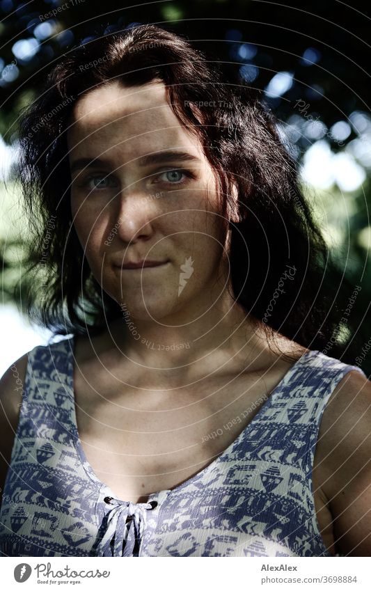 Nahes Portrait einer sommersprossigen Frau in einem Wald im Sommer zart Schatten Licht sportlich feminin Empathie Gefühle emotional Blick in die Kamera Porträt