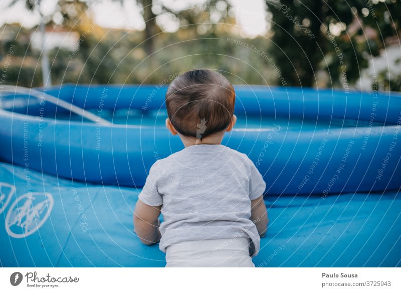 Kleinkind auf dem Pool Beckenrand aufblasbar Sommer Sommerurlaub Kind Baby 0-12 Monate Sicherheit sicher gefährlich Spielen schön Außenaufnahme Tag niedlich