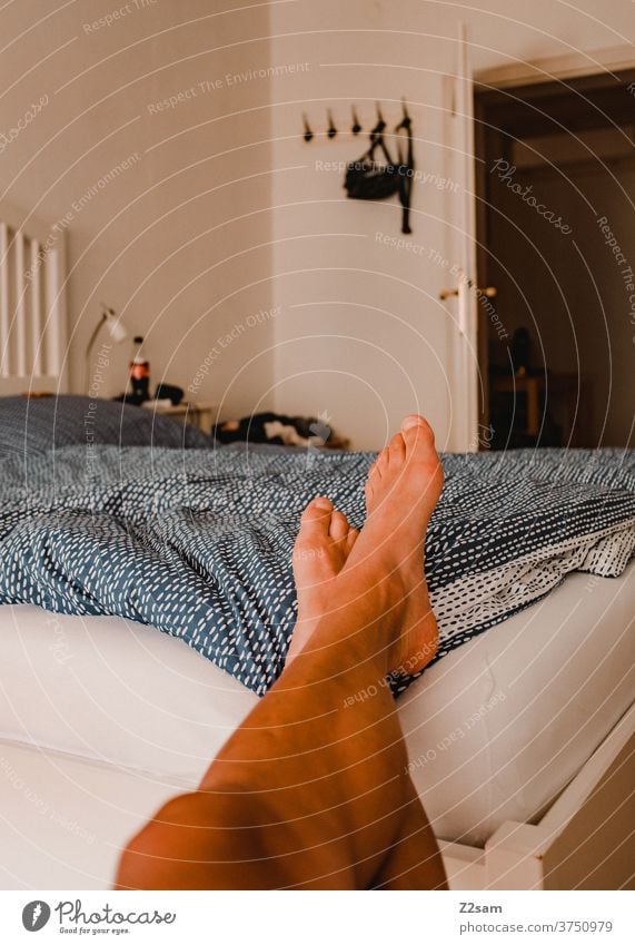 Junger Mann entspannt im Schlafzimmer Bett zuhause erholung entspannung wohnen gemütlich altbau liegen ausruhen schreiben entspannen wochenende freizeit Morgen