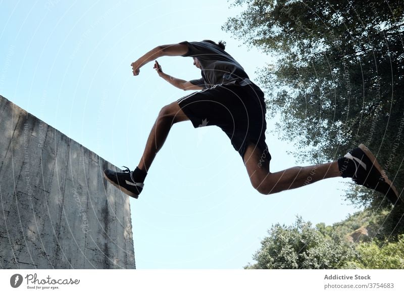 Mann springt in der Stadt über den Boden Le Parkour springen Stunt Trick Großstadt urban extrem Gefahr Hobby männlich Mut aktiv gutaussehend Aktivität