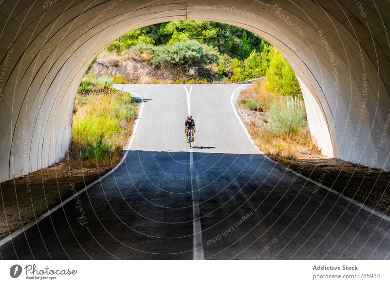 Radfahrer fahren Fahrrad unter Brücke in der Landschaft Mitfahrgelegenheit Straße Mann Bogen aktiv Lifestyle Sport Aktivität Gesundheit Sommer Viadukt Torbogen