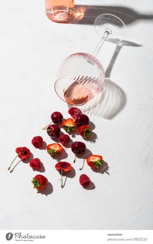 Konzeptkomposition, die Rosenwein-Aromen von Sommerfrüchten von Beeren präsentiert Wein Glas Kelch Zusammensetzung Flachlegung Geschmack Frucht Schatten rot