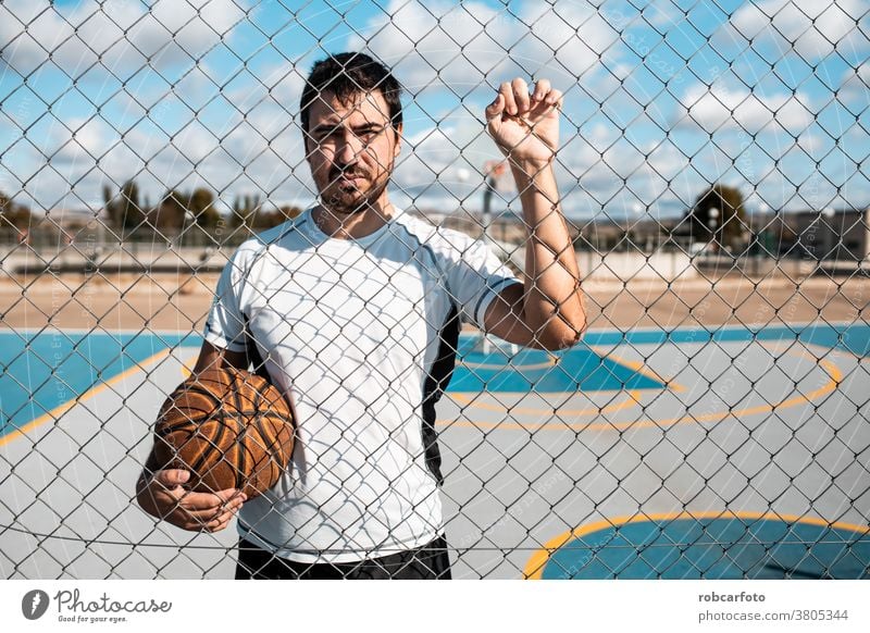 Mann, der auf der Straße auf einem Außenplatz Basketball spielt. Spaß Sport urban Menschen cool Männer Ball Schuss jung Spiel männlich Erwachsener Gericht
