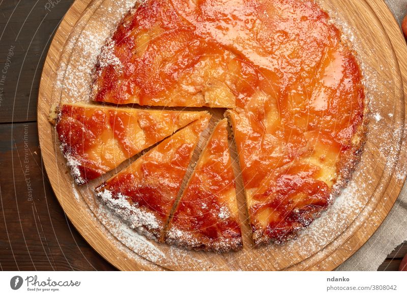 gebackener runder Apfelkuchen auf Holzbrett a oben Amerikaner Pasteten süß Tisch Torte geschmackvoll Erntedankfest Top traditionell ganz hölzern Herbst braun