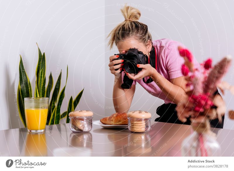 Frau nimmt Foto von Essen im Wohnzimmer Food-Fotografie Photo-Shooting professionell Lebensmittel fotografieren orange Saft Dessert Mahlzeit Glas heimwärts