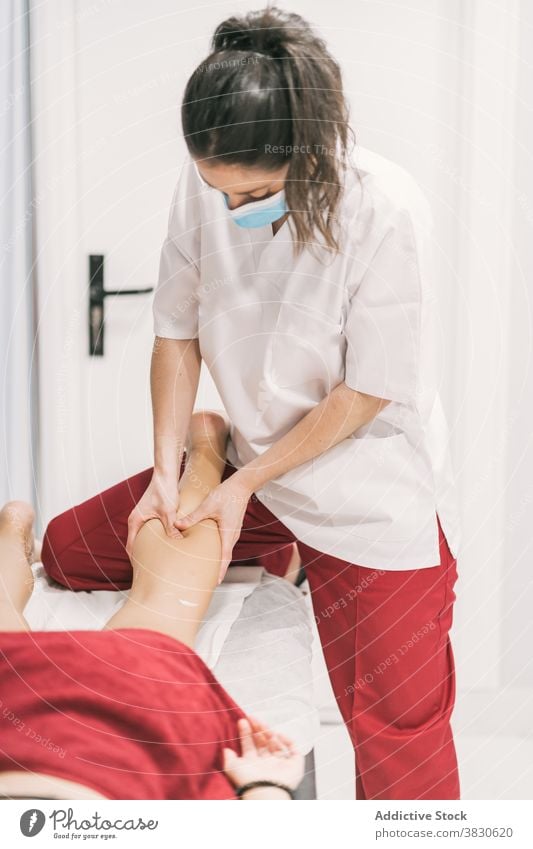 Massagetherapeutin massiert Beine eines Patienten Therapie Physiotherapie Arzt geduldig Masseurin Leckerbissen Rehabilitation Verfahren Gesundheit professionell