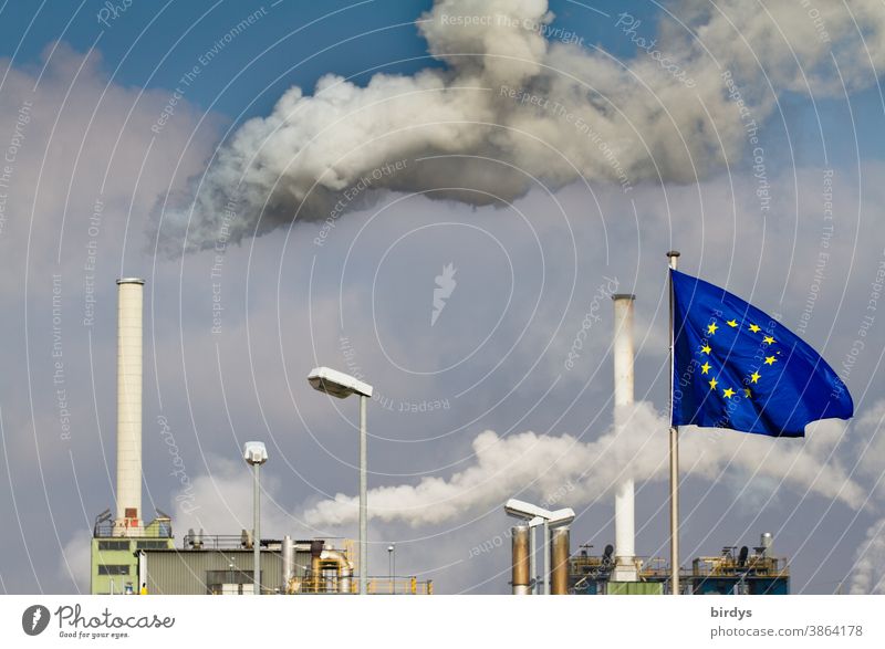 Rauchende Industrieschornsteine . Fabrik mit Europafahne davor .Europäische Union CO2-Ausstoß EU Industrieanlage Schornstein Luftverschmutzung Klimawandel