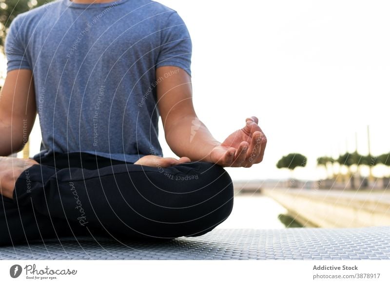 Gelassener Mann in Lotus-Pose im Park vermittelnd meditieren Yoga Harmonie Asana padmasana beweglich Beine gekreuzt üben männlich Unterlage sich[Akk] entspannen