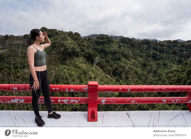 Asiatische Frau genießt die Aussicht auf ein Bergtal Aussichtspunkt Berge u. Gebirge Hochland Reisender bewundern beobachten Tal Sommer erkunden ethnisch