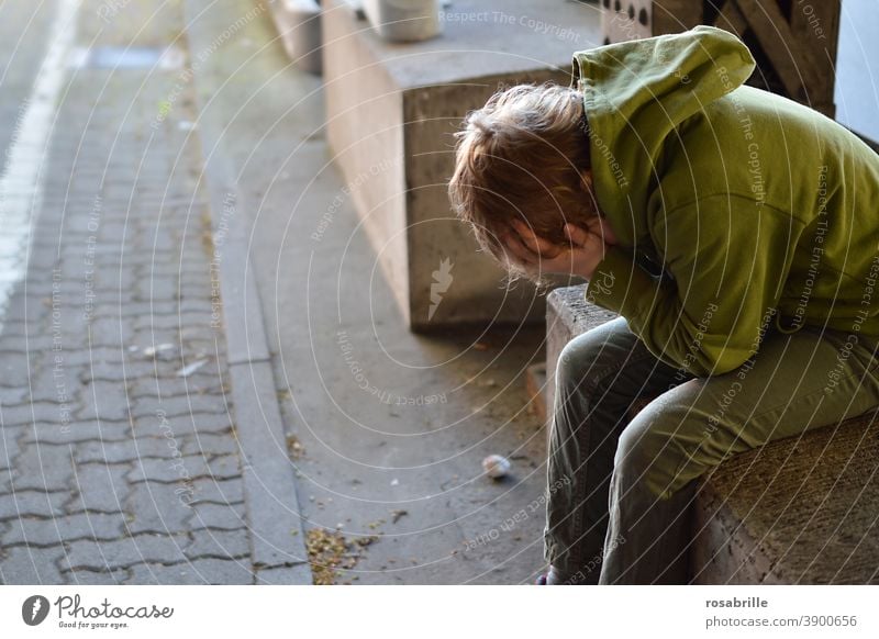 Lebensbrüche  | kleiner Junge sitzt verzweifelt mit den Händen vor dem Gesicht weinend in einer Unterführung traurig Kind alleine Trauer Sorge Angst Verlust