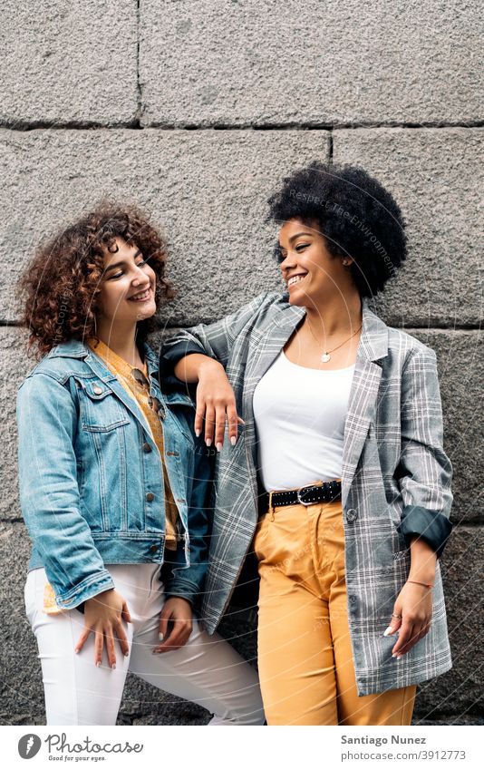 Cool Afro Mädchen und Freund in Straße Frauen die sich gegenseitig ansehen multiethnisch Afro-Mädchen Kaukasier Porträt Spaß haben Vorderansicht Freunde