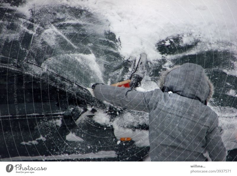 Im Winter das Auto vom Schnee frei fegen und Eis kratzen - ein