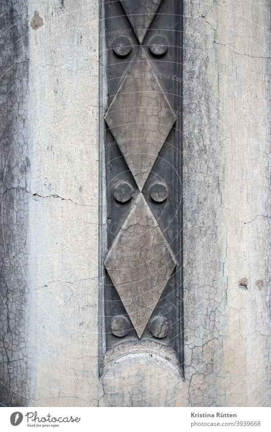 geometrisches muster an hausfassade ornament hauswand mauer gebäude dekorativ fassadenelement schmuckelement fassadengestaltung abstrakt punkte kreise rauten