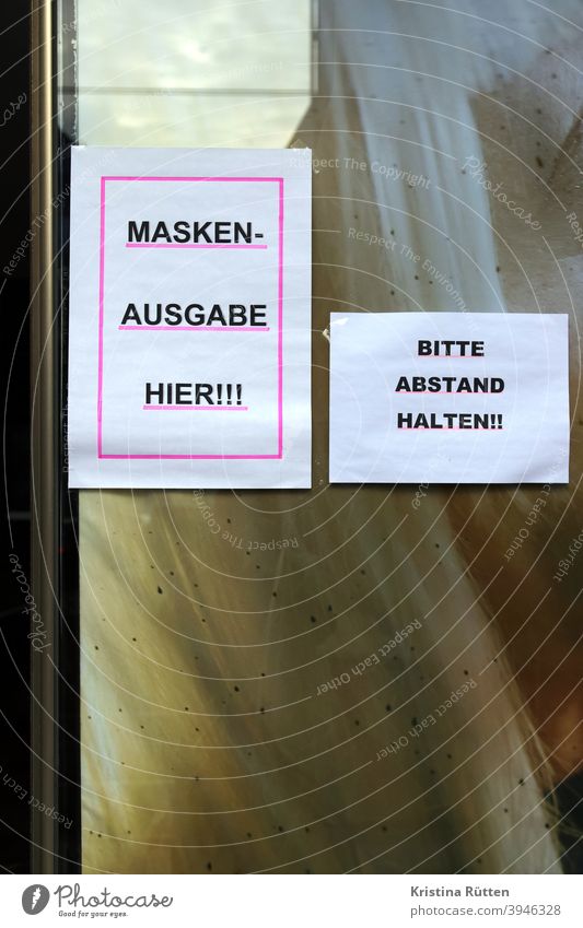 zettel am apothekenfenster: maskenausgabe hier und bitte abstand halten mundschutz ffp2 ffp2-maske schutzmaske mns verteilung kostenlos umsonst schild hinweis