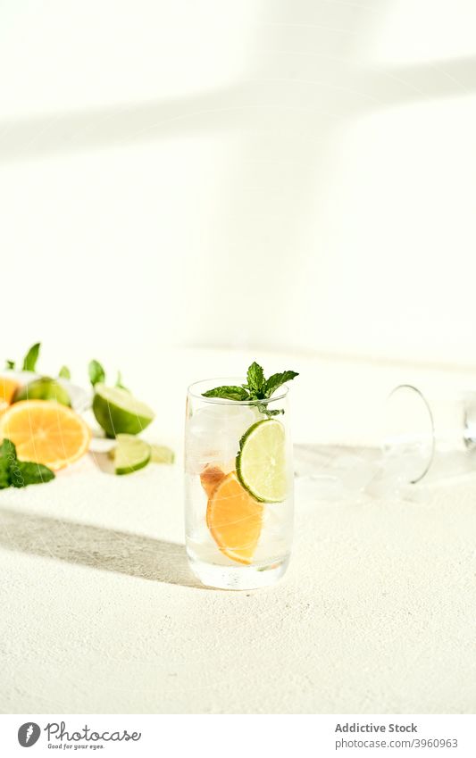 Glas frischer Cocktail mit Limette und Zitrone Kalk Wasser aufgießen trinken Limonade Erfrischung Minze Zitrusfrüchte Getränk Scheibe Mojito Garnierung lecker
