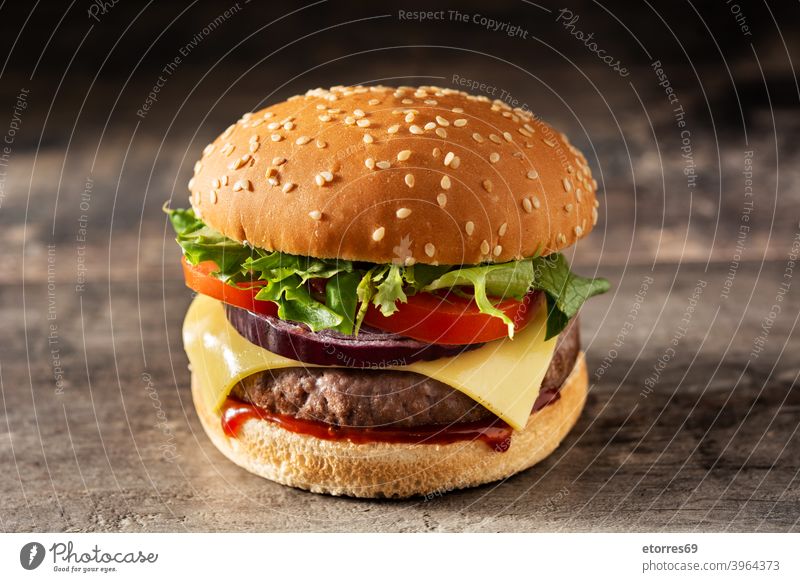 Cheeseburger mit Rindfleisch, Tomate, Kopfsalat und Zwiebel Amerikaner Barbecue Brot Burger Käse klassisch Nahaufnahme lecker Abendessen Fastfood Lebensmittel