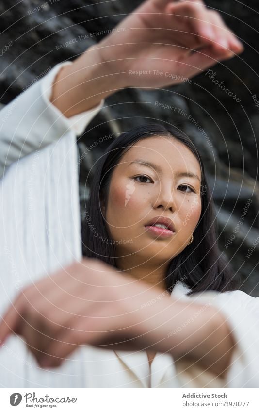 Stilvolle Frau in modischer Kleidung steht in der Nähe von Felsen Mode elegant Outfit weiß Flügel Model Porträt Quaste Anzug jung asiatisch ethnisch trendy