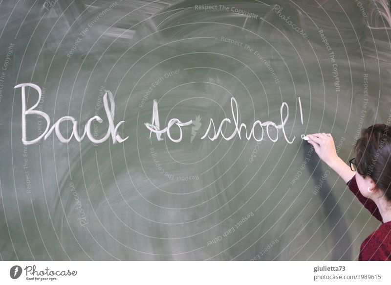 Back to school - Junge Lehrerin schreibt mit Kreide an die Tafel Schule Schulunterricht zurück zur Schule Präsenzunterricht 18-25 Jahre Unterricht Tag