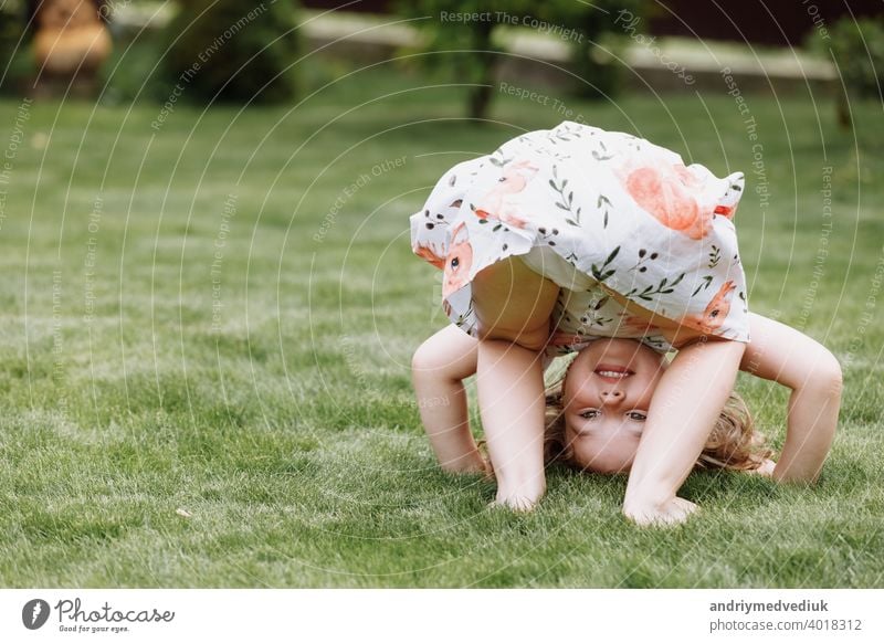 Kleines glückliches Mädchen, das Spaß im grünen Sommerpark hat. glückliche Kindheit schön niedlich Natur Frühling Gras jung Fröhlichkeit Glück Freude wenig