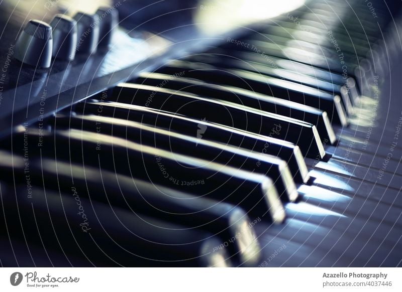 Elektrische Klaviertastatur in Unschärfe. Klaviertastatur mit Tageslichtreflexionen. akustisch Audio Hintergrund Band schwarz blau Bokeh Kind Akkord Klassik