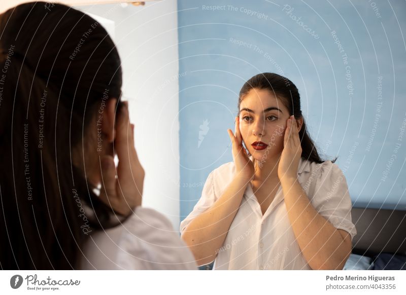 Schöne Frau reinigt ihr Gesicht vor einem Spiegel frisch konstruiert geschliffen weiß berühren Schminke Schönheit Sauberkeit nach oben Reinigung Hand Auge sexy