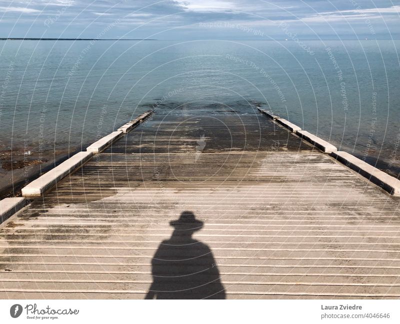 Der Schatten und das Meer MEER Strand Bootsrampe Wasser Himmel Menschen Schatten Küste Horizont Farbfoto Sommer Natur Warten Silance Hut-Schatten Windstille