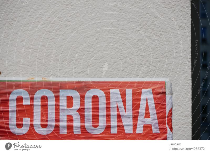 Weißer Schriftzug "Corona" auf rotem Hintergrund vor heller Hauswand Virus coronavirus Corona-Pandemie Coronavirus SARS-CoV-2 coronakrise weiß Wort Corona-Virus
