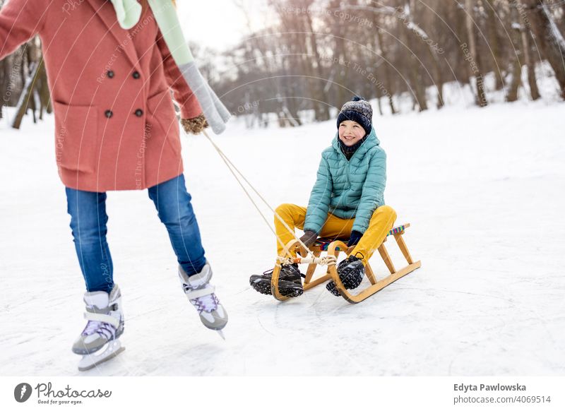 Mutter und Sohn haben einen großen Wintertag im Freien spielen im Schnee Tochter Saison Zusammensein gefroren heiter Spaß Kind Menschen Park Feiertag Wald