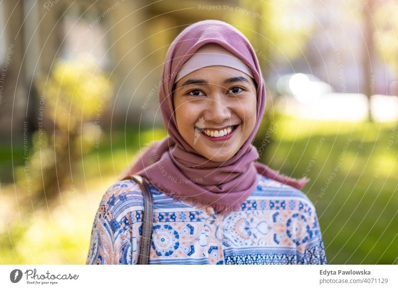 Lächelnde junge Frau trägt Hijab im Freien Kopftuch muslimisch Islam arabisch Sommer Mädchen Menschen junger Erwachsener Lifestyle aktiv tausendjährig außerhalb