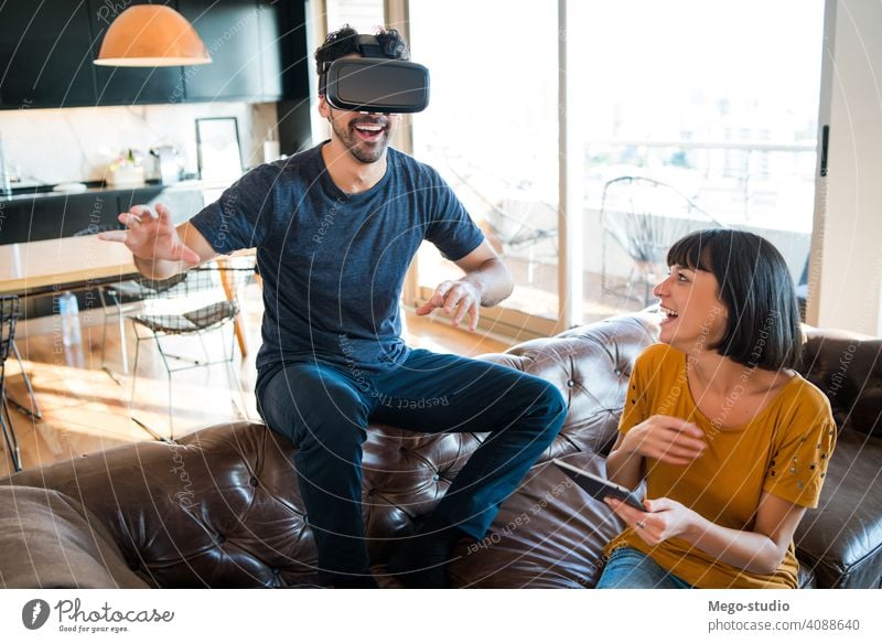 Ein Paar spielt Videospiele mit einer VR-Brille. Realität digital Tablette Spielen Schutzbrille Simulation Gerät Entertainment im Innenbereich jung Headset