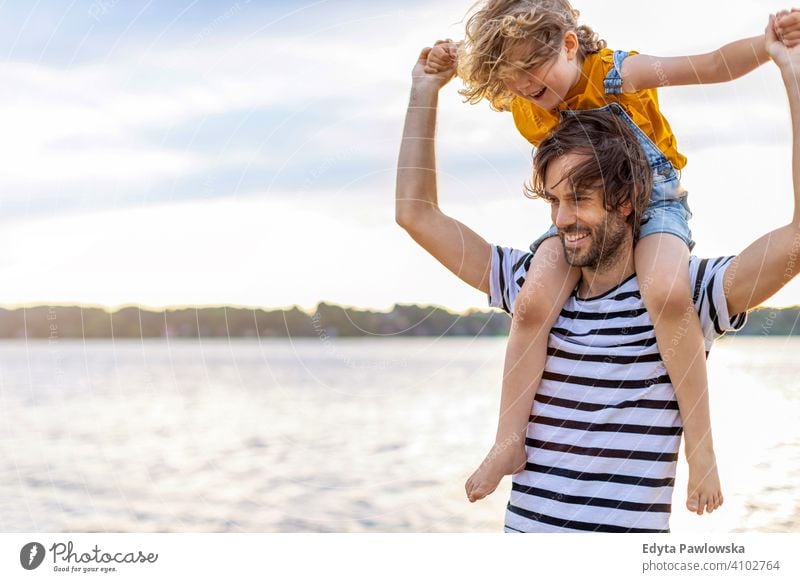 Vater mit einem Kind den Tag am Strand verbringen MEER See Feiertage Urlaub Natur Sommer Familie Eltern Sohn Junge Kinder Zusammensein
