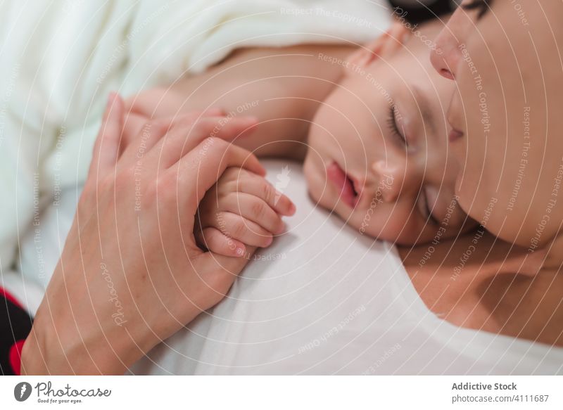 Friedliches Baby an der Brust der Mutter schlafen Truhe Zusammensein Kind bezaubernd wenig niedlich unschuldig Pflege sich[Akk] entspannen ruhen Liebe Zuneigung