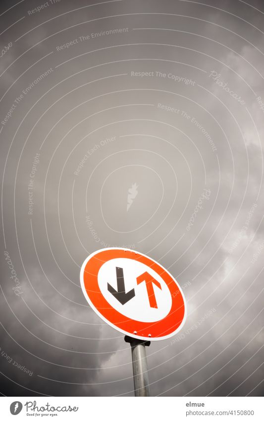 Verkehrszeichen " Vorrang des Gegenverkehrs " vor dunklen Wolken / VZ 208 / warten / Engstelle Verkehrsschild bedeckt Straßenschild Wartepflicht Regel