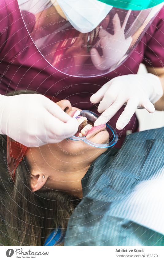Gesichtsloser Zahnarzt, der die Zähne einer Patientin untersucht dental geduldig untersuchen Klinik Stomatologie professionell Gesundheitswesen Zahnmedizin