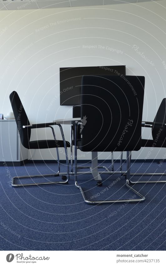 Verlassenes Büro mit 4 Stühlen, Tisch in der Mitte und Bildschirm an der Wand büro Schreibtisch Arbeitsplatz Business Arbeit & Erwerbstätigkeit Farbfoto