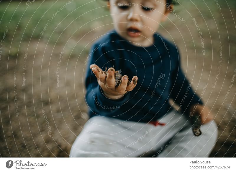 Kind spielt im Freien mit Erde Boden Schlamm dreckig Neugier erkunden authentisch Spielen Natur Farbfoto Kaukasier Lifestyle Glück Kindheit Freude Leben