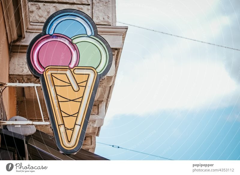 Eiswaffel mit drei Eiskugeln über einer Eisdiele Speiseeis Sommer Farbfoto Ernährung Lebensmittel Süßwaren süß Waffel Dessert lecker Außenaufnahme