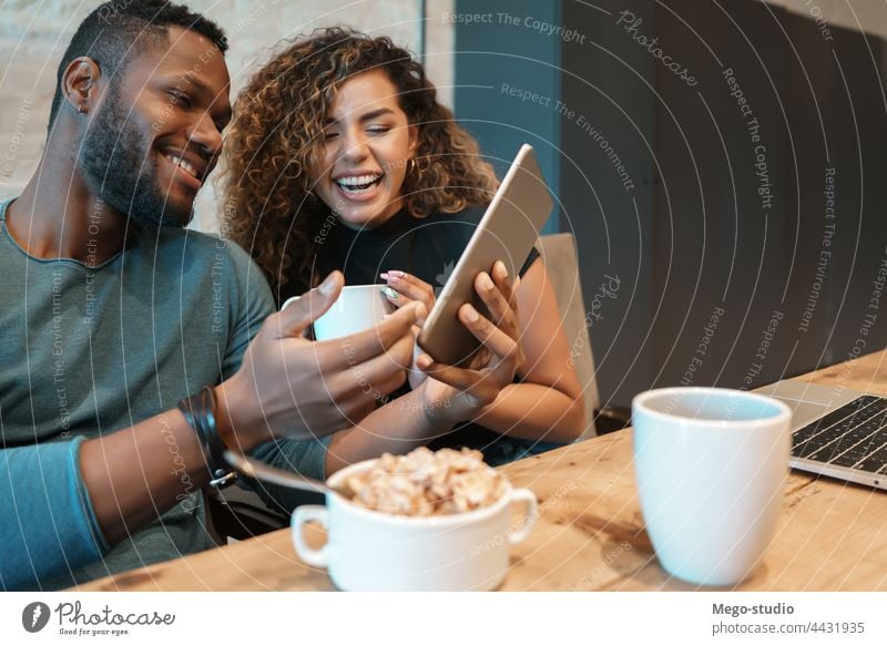 Ein Paar benutzt ein digitales Tablet beim Frühstück. jung Zusammensein Tablette im Innenbereich Lifestyle Quarantäne digitales Tablett Lebensmittel Küche
