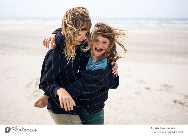 Zwei Schwestern spielen am Strand Freundschaft Schwesternschaft Liebe Zusammensein MEER Sand Himmel Wasser Urlaub reisen aktiv Abenteuer Sommerzeit Tag Freiheit