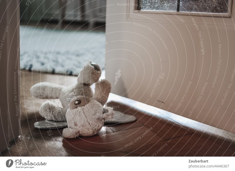 Teddybär liegt in halb geöffneter Tür zum Kinderzimmer Spielzeug liegen Kindheit Angst Missbrauch Stofftier Traurigkeit traurig Einsamkeit Trauer Aufräumen