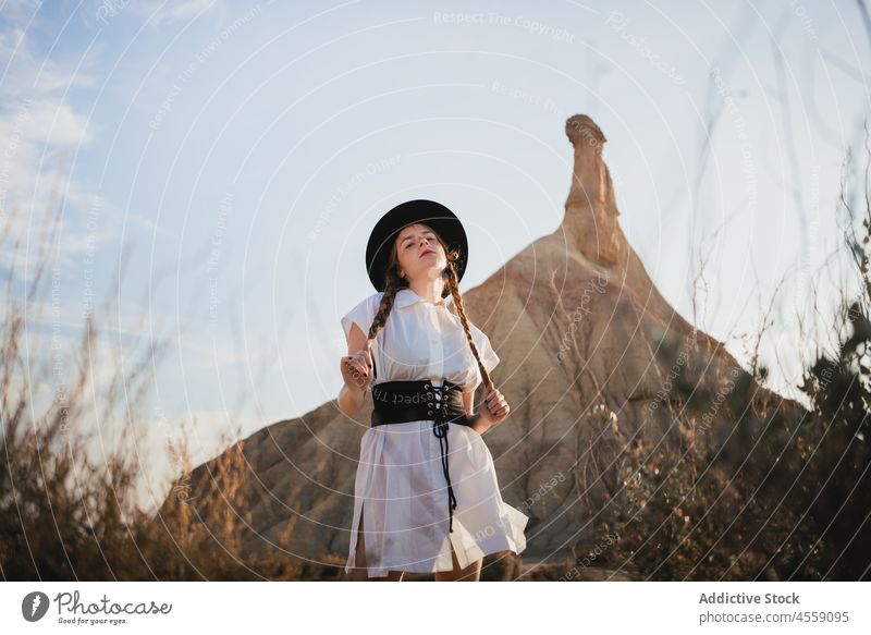 Unbeschwerte Frau mit Zöpfen in der Nähe des Berges von Bardenas Reales Spanien Park Natur Berge u. Gebirge castelditierra Navarra Klippe sich[Akk] entspannen