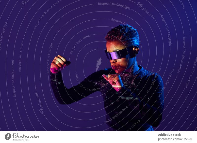 Futuristische schwarze Frau boxt mit VR-Brille Virtuelle Realität Boxsport Spiel kämpfen Schutzbrille modern Cyberspace dunkel Hallo Technik