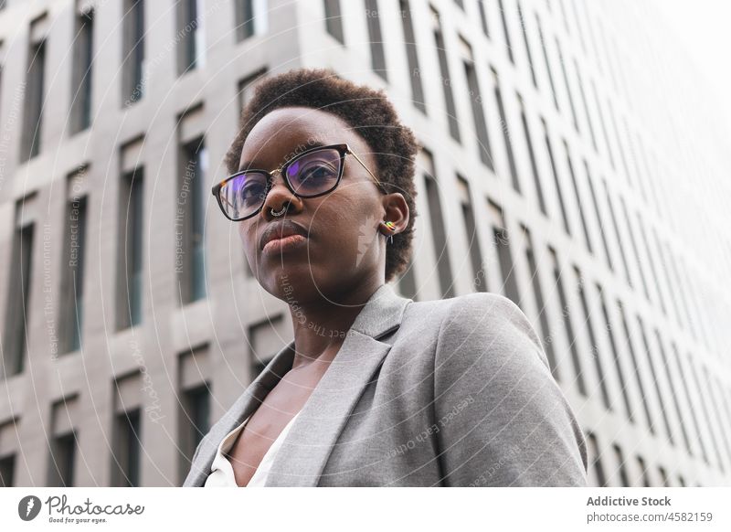 Stilvolle selbstbewusste schwarze Geschäftsfrau in der Nähe eines modernen Bürogebäudes Frau Unternehmer Großstadt Wolkenkratzer Straße Gebäude stilvoll