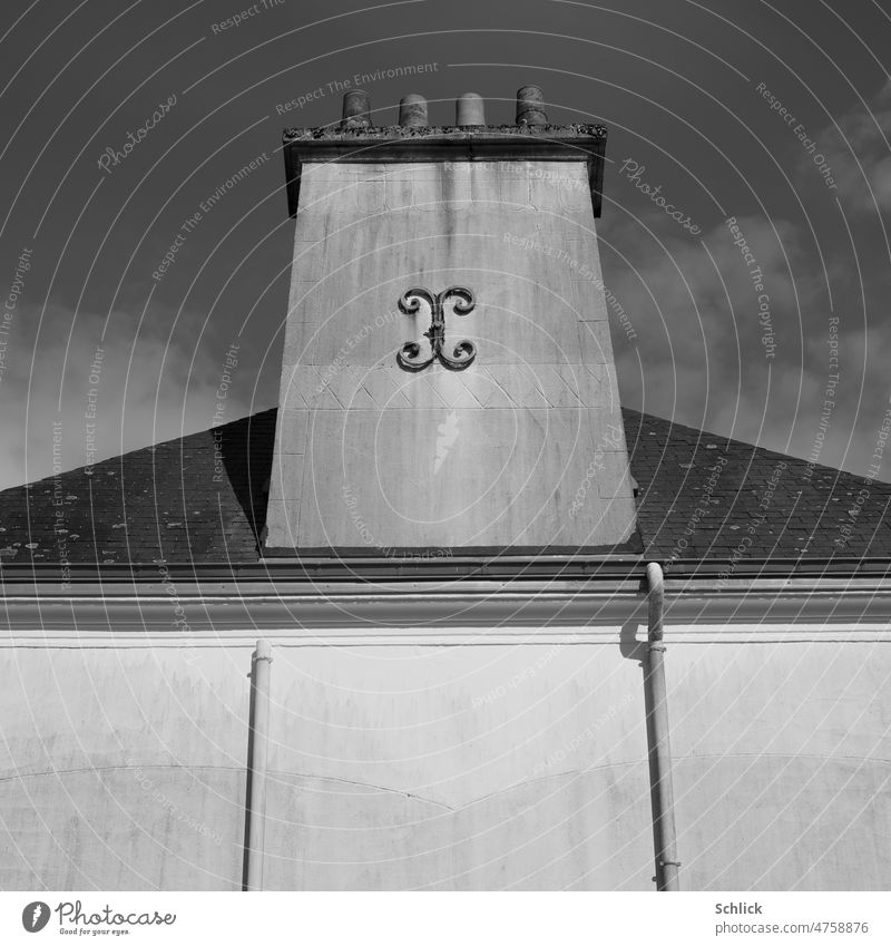 Bretagne 2022 Kamin einer Ofenheizung mit 4 Zügen Froschperspektive schwarzweiß Außenaufnahme Dach Haus SW Regenfallrohr Himmel Heizung