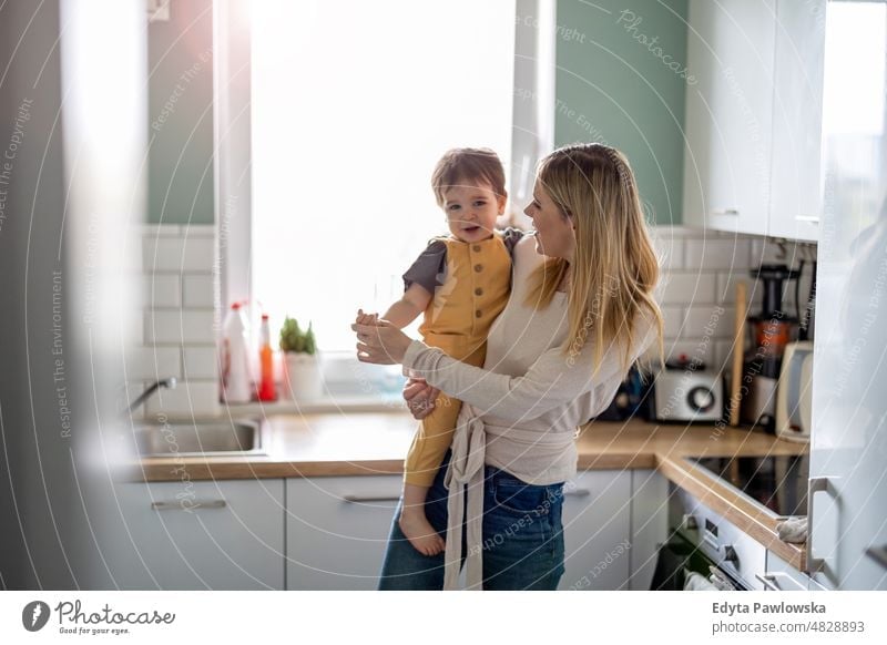 Junge Mutter mit Kind in der Küche Erwachsener Zuneigung Baby Bonden offen Pflege Kindheit heimisch genießend Familie Spaß Fröhlichkeit Glück heimwärts Haus