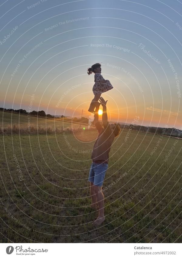 Vater und Tochter natur Abens Sonnenuntergang Sonnenstrahlen Wiese Hecken Vater Tochter Kind Papa Zusammensein Eltern Liebe Mädchen Familie Saß Freude Kindheit