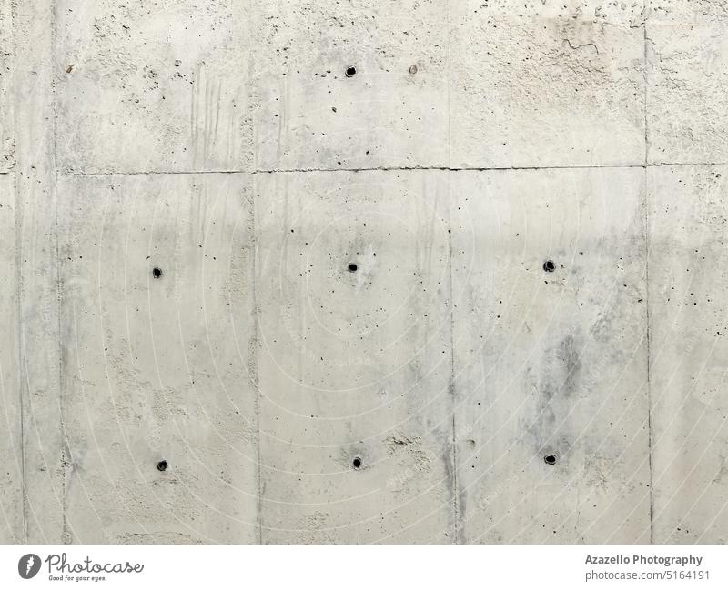 Hintergrund einer Betonwand mit Bohrlöchern. Farbe Nahaufnahme niemand zerknittert Monochrom Beschädigte gekratzt verschmiert grau Struktur Oberfläche weiß