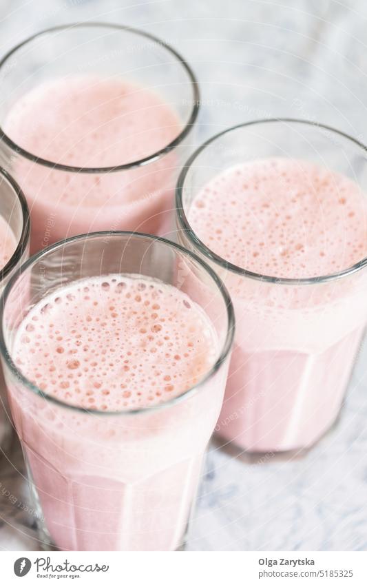 Blick von oben auf Gläser mit Erdbeermilchshake oder Smoothie auf dem Tisch. Milchshake Erdbeeren Beeren Gesundheit aktualisieren trinken rosa Draufsicht Glas