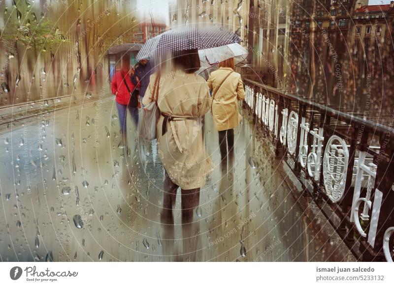 Menschen mit Regenschirm an regnerischen Tagen in der Wintersaison, Bilbao, Baskenland, Spanien Person Fußgänger eine Person regnet Regentag Regenzeit Wasser